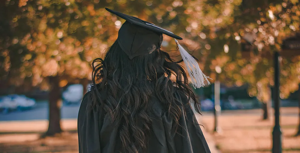 back of woman in graduation cap and gown